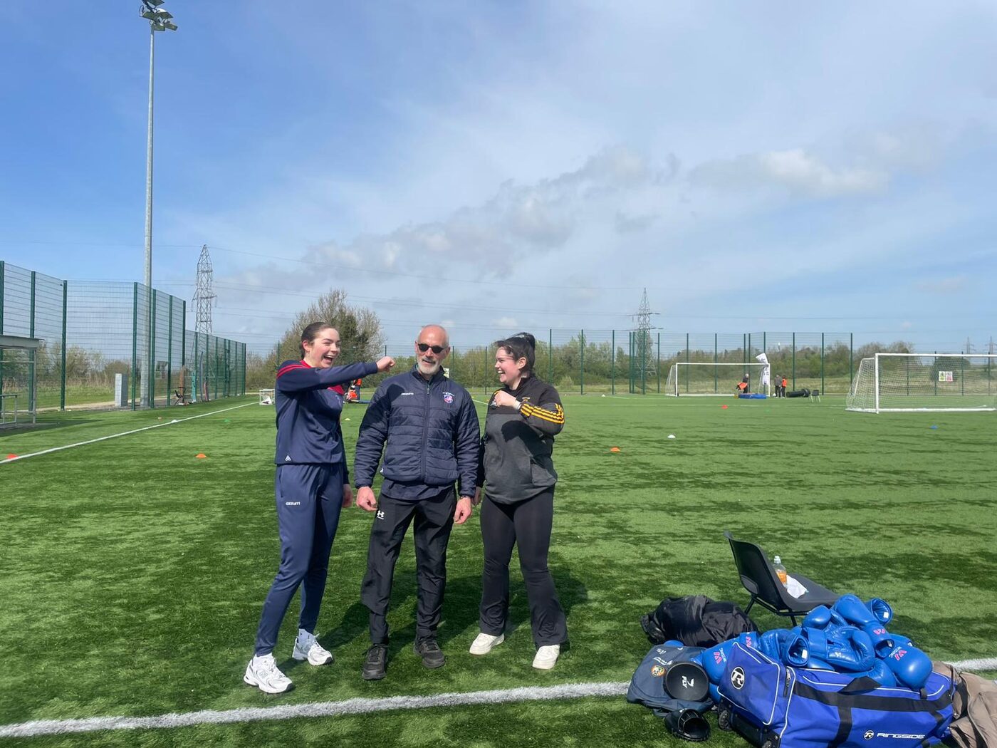 A group of students taking part in an outdoor boxing fitness session